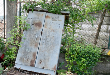 BANGKOK, THAILAND - February 15, 2024: Old rusty iron cabinet abandoned on the side of the road...