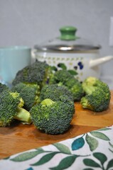 cooking broccoli in the kitchen near the pan, recipe, pieces of broccoli, cabbage on a wooden board