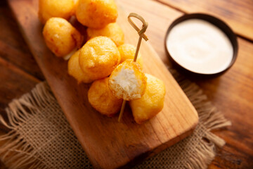 Fried breaded cheese balls, easy and delicious homemade snack recipe. Served with dipping sauce.