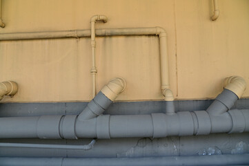 Closeup of Colorful PVC Pipe for water system work on yellow wall in the building construction at...