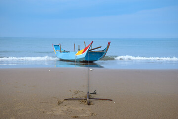 Adorable little boat docked at beach in a peaceful day, in Jinshan, New Taipei City, Taiwan.
