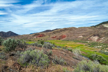 The John Day River flows across the sage-covered landscape of the John Day Fossil Beds National Monument, Oregon, USA
