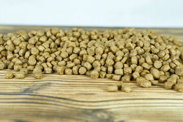 Dry cat food on a wooden background. Selective focus.