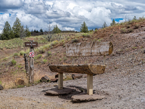 A log park bench at the end of the Red Hill Trail in the Painted Hills Unit of the John Day Fossil Beds National Monument, Oregon, USA