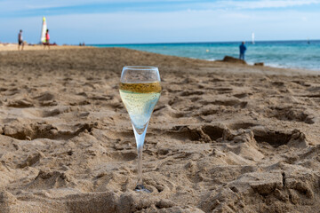 Pouring a glass of champagne on vacation, south of Fuerteventura, Canary islands, blue ocean, mountains