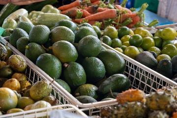 Fresh ripe green avocados, tropical fruits and vegetables on farmers market on Fuerteventura, Canary islands, Spain