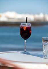 Glass of cold sangria wine served with orange in beach cafe, Corralejo, Fuerteventura, Spain