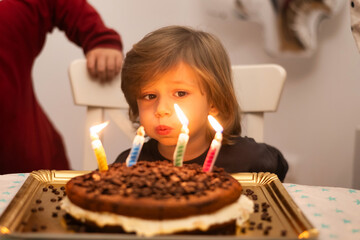 Child Blowing Out Cake Candle.Kids Birthday Party. 