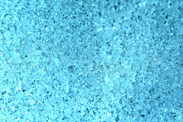 Fototapeta na wymiar 明るいターコイズブルーに色調加工したシャーベット状の雪面テクスチャー。