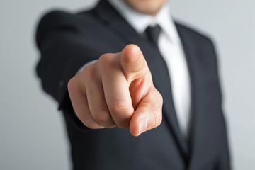 Businessman in suit pointing with hand, conveying success and agreement gesture