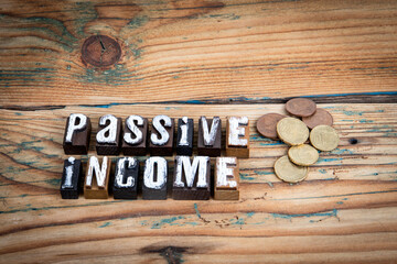 Passive income. Alphabet letters on wood texture background