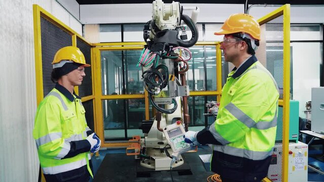 Engineer working and controlling robotics with monitoring system software automation robot arm. AI, Artificial intelligence.