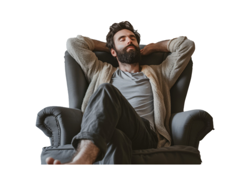 Handsome bearded man stretching in grey armchair