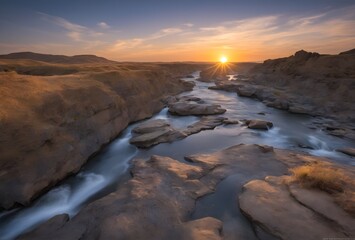 Majestuoso Paisaje remoto rio salvaje rodeado de rocas al atardecer , el sol ocultandose en el horizonte. - obrazy, fototapety, plakaty