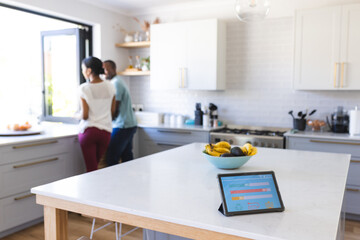 Young biracial woman and African American man in a modern kitchen