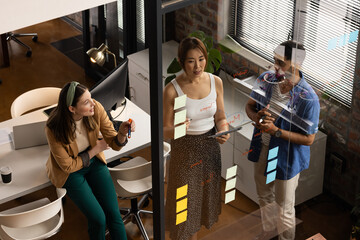 Diverse team discusses project in a casual business office, with copy space