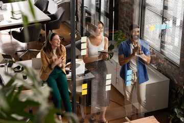 Young Caucasian woman and young Asian man in a casual business office setting