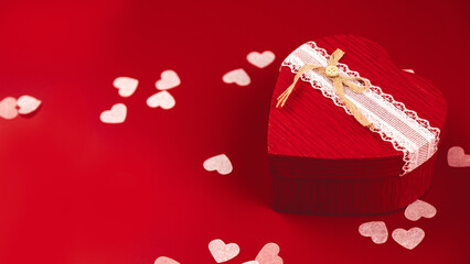 Valentine's Day concept. Valentine's Day background. Gifts, confetti, card on a red background....