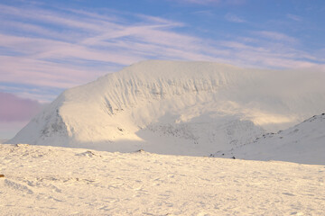 Fototapeta na wymiar snowy mountain in Norway with clouds
