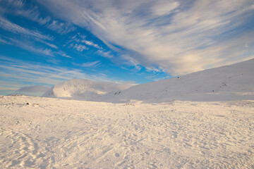 snowy mountain in Norway with clouds