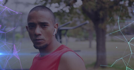 Image of glowing purple and blue networks over portrait of determined male athlete outdoors