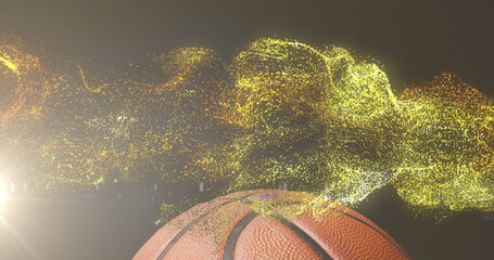 Image of glowing gold particles moving over basketball