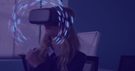 Image of glowing light trails of data transfer over caucasian woman in vr headset
