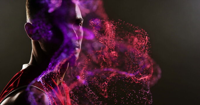Image of red particles over african american male basketball player