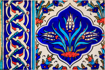 Ornate blue and red handmade Turkish Iznik mosaic tiles with floral Islamic patterns in a traditional Ottoman style in Istanbul, Turkey
