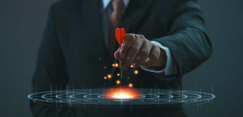 Executive marketing Businessman hand holding red arrow dart and throwing to the center of virtual...