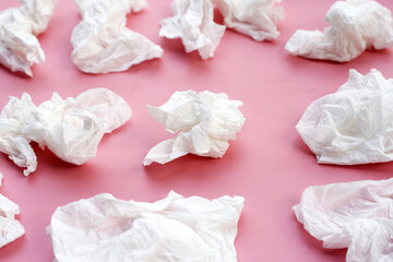 Fototapeta na wymiar Crumpled tissue paper. Facial tissue on pink background.