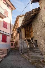 Fototapeta na wymiar Old residential buildings in the historic hill village of Timau in Udine Province, Friuli-Venezia Giulia, North East Italy. Part of the Paluzza municipality, Val But, Carnia Alps
