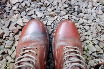 a pair of red men's boots on the rocks.