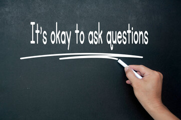 Hand writing It is okay to ask questions affirmation on black board. Affirmation concept