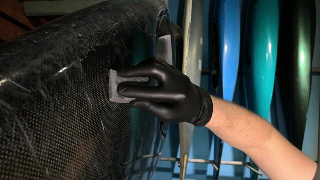 working with resin. kayak repair. vertical video. slow motion video. High quality video in 4K format.