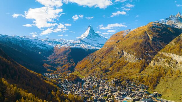 Hyper lapse or drone time lapse aerial view of Zermatt village in autumn season with beautiful landscape of Matterhorn, Most popular travel destination in Switzerland.
