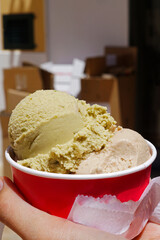 Close up Hand holding red paper take away cup of ice cream gelato