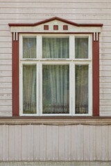 Window with white frame on a wood wall.
