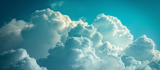 A cluster of cumulus clouds floating in an electric blue sky, resembling a meteorological phenomenon, creates a mesmerizing liquid-like font. - obrazy, fototapety, plakaty