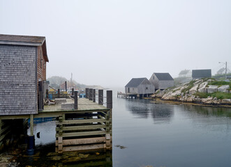 Beautiful and quaint working harbor and port of Peggy's Coved on Nova Scotia on a foggy summers day - 731558165