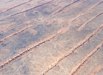 fences on red sand dune stripes in Kalahari, east of Kalkrand, Namibia
