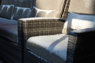 Fototapeta na wymiar Snow on garden furniture cushions made of waterproof and heat-resistant fabric