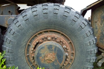 Fototapeta na wymiar Closeup of old rusty wheel rim of haul truck.