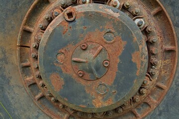 Closeup of old rusty wheel rim of haul truck.