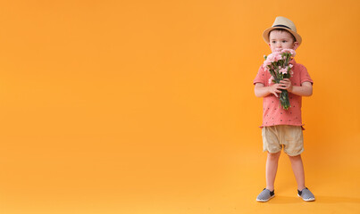 Little boy with a bouquet of flowers.