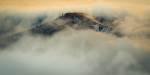 Fototapeta premium Lone peaks emerge from the morning fog in Eastern Washington's backlands on an early winter day
