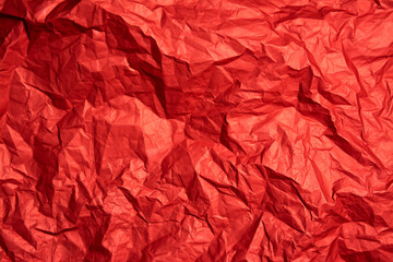 Fototapeta premium Crumpled red sheet of paper. Paper texture. Background for designers. Paper layout.