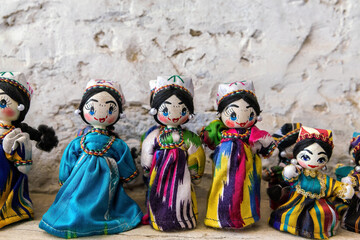 Dolls dressed in traditional uzbek costumes. Traditional souvenir puppet from painted mashed paper...