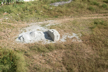Pile of White Bricks and Lime Heap in a Dry Field in During Daytime