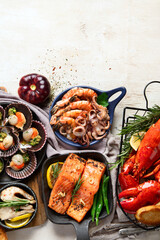 Set of Seafood dishes on light wooden background.